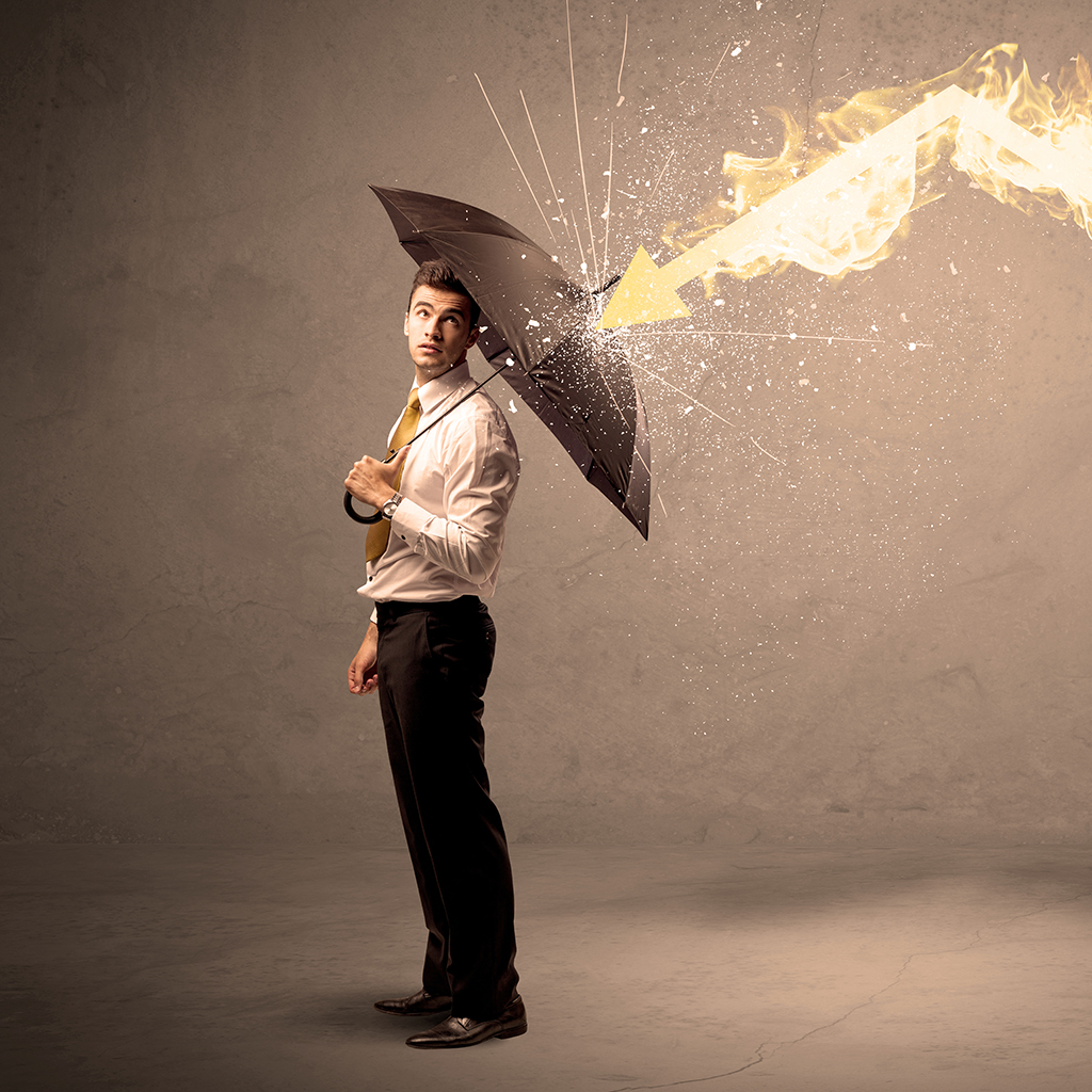Business man defending himself from a fire arrow with an umbrell